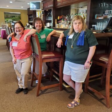 Angie, January, and Kari at the golf tournament.