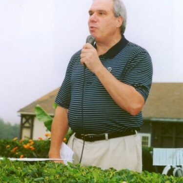 Reverend Monsignor Bob Cilinski delivering remarks at the Gabriel Homes golf tournament.
