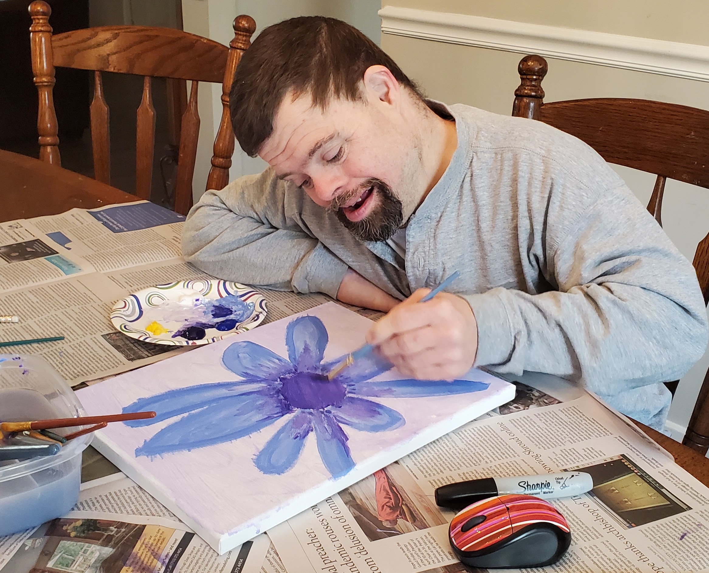 Gabriel Homes resident painting on a canvas.