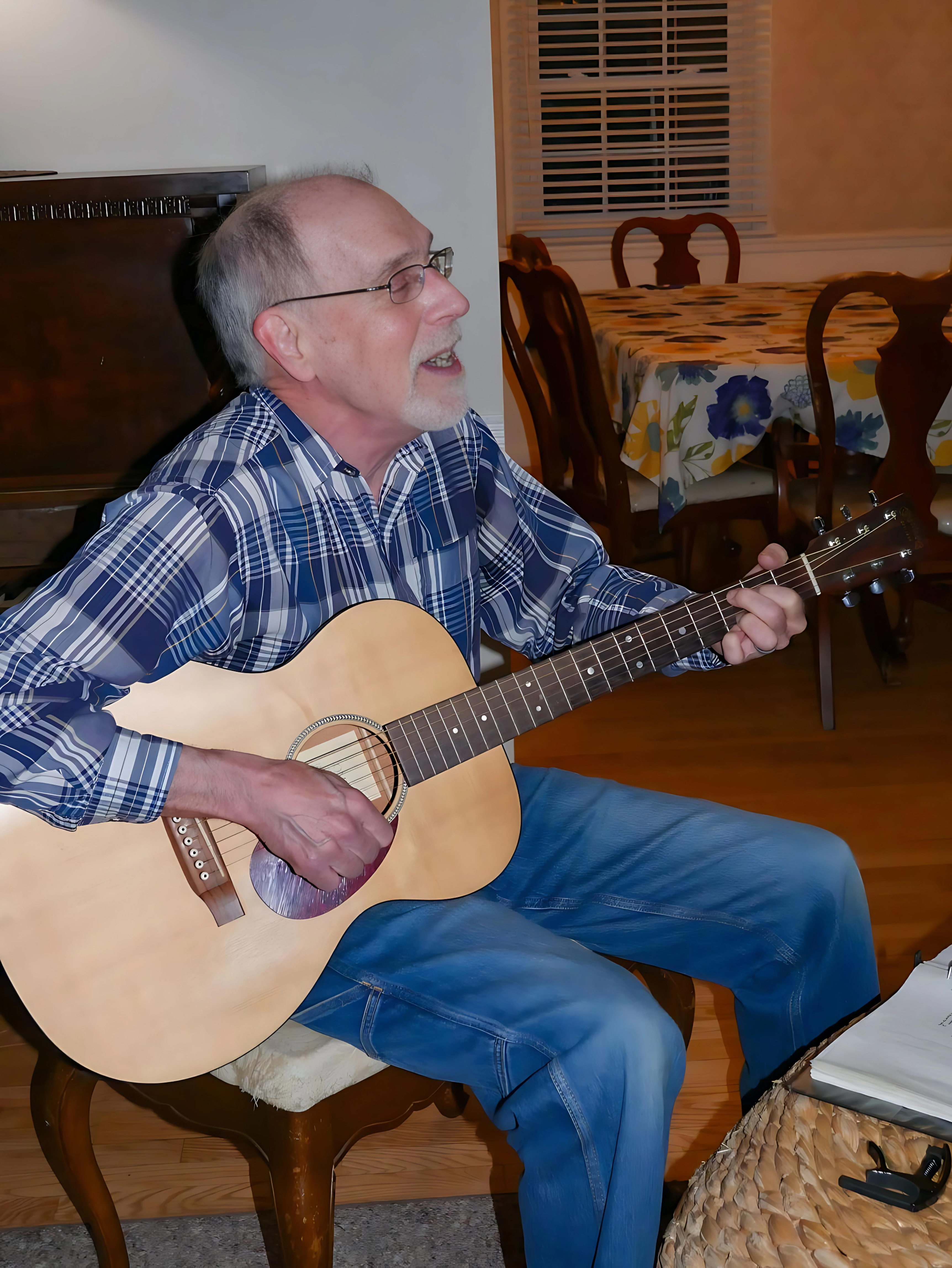 Bill Partlow playing guitar.