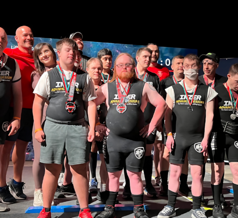 Gabriel Homes residents at powerlifting tournament with their team.
