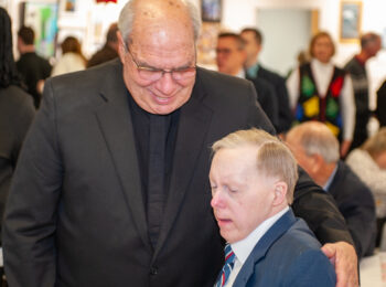 Gabriel Homes resident (right) with Father Bob Cilinski (left).