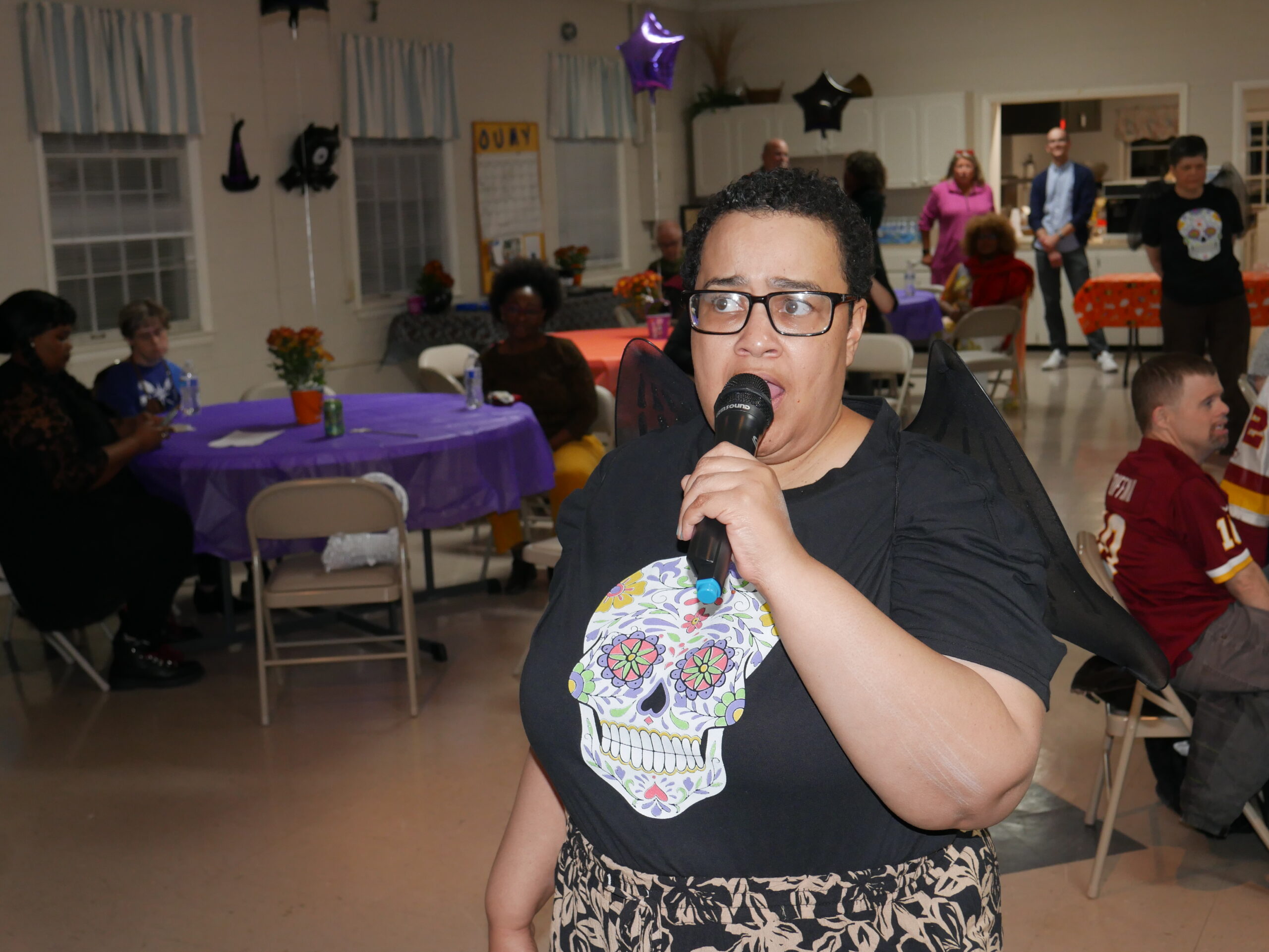 Gabriel Homes resident singing karaoke at the Boo Bash.