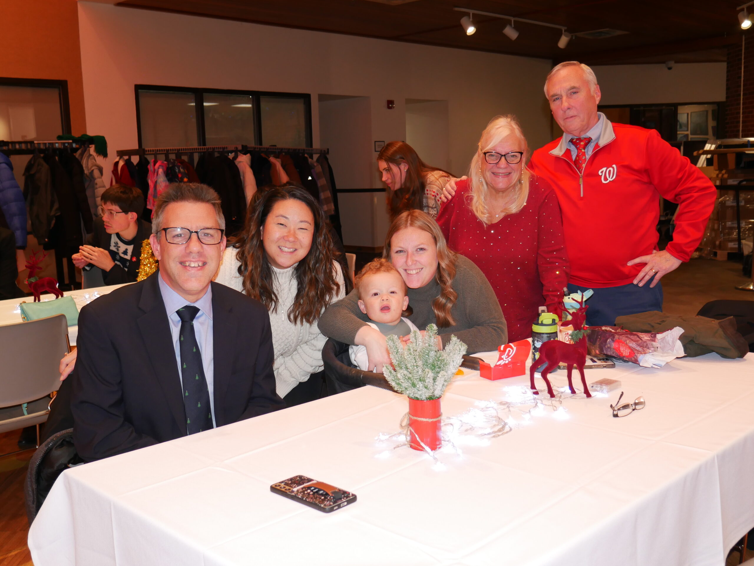 Gabriel Homes resident (left) and his family at the 2024 Christmas party.