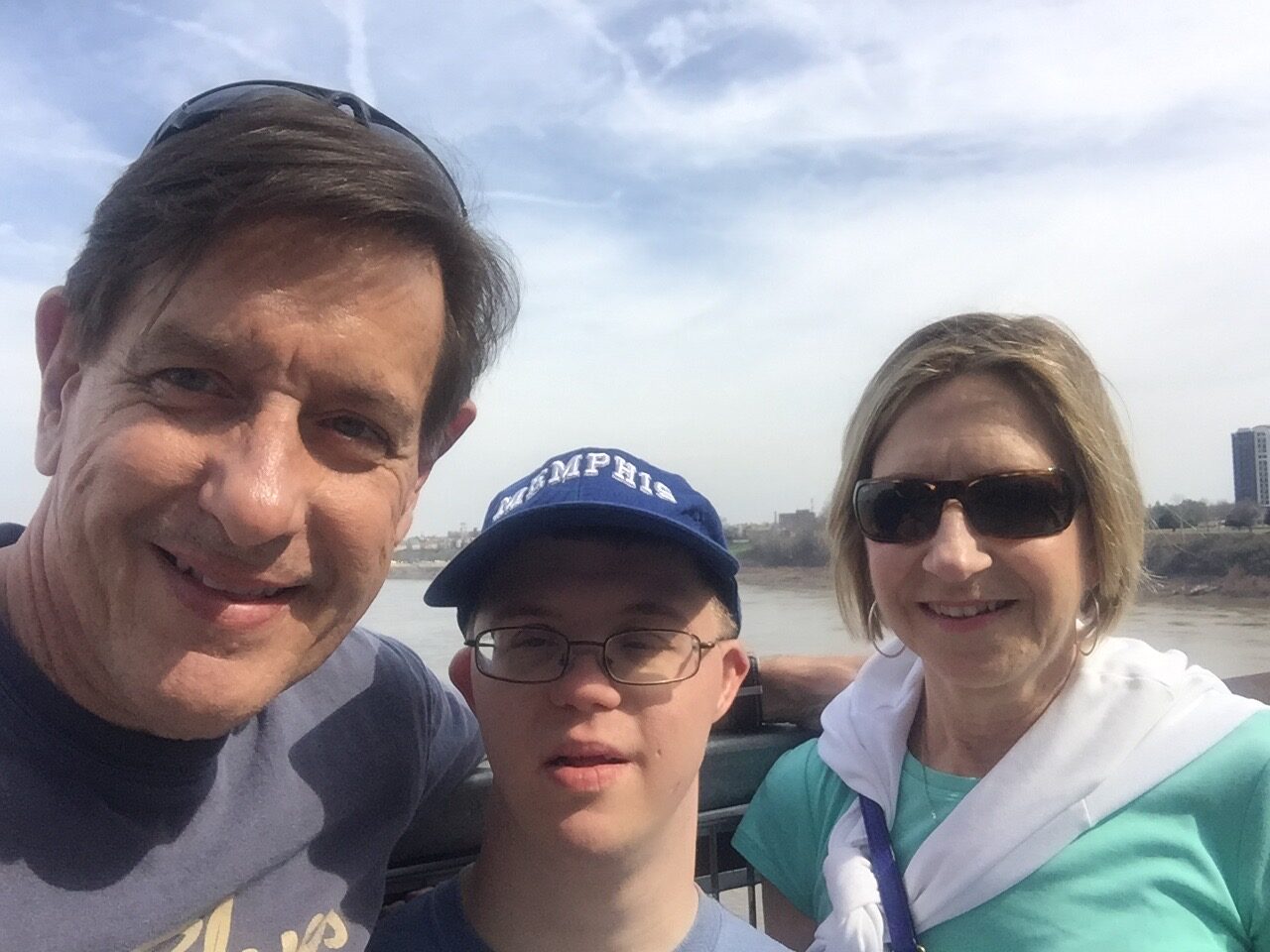 Gabriel Homes resident (center) with parents in front of Memphis skyline.