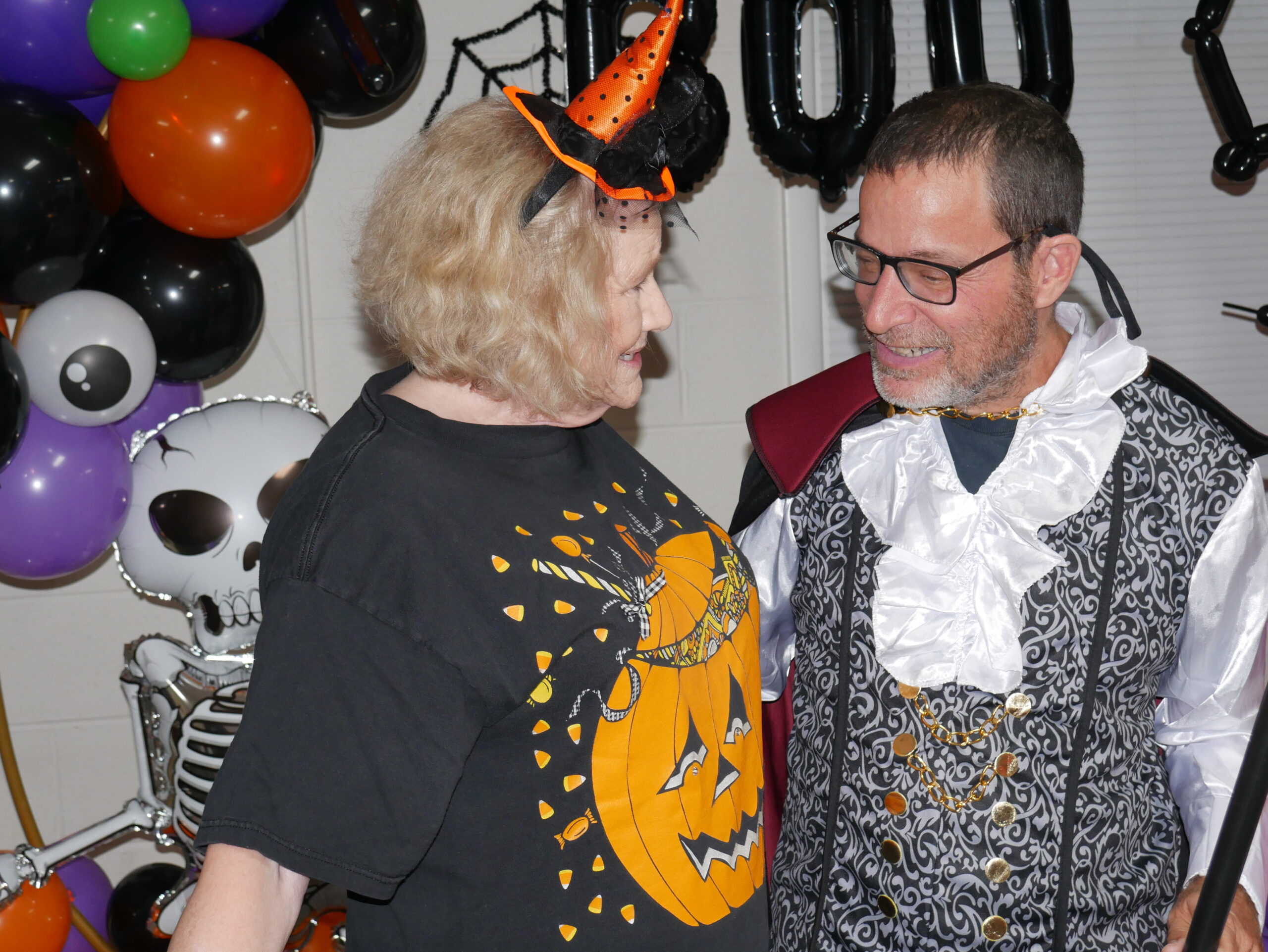 Ruth Cook (left), bookkeeper at Gabriel Homes, laughing with resident (right).