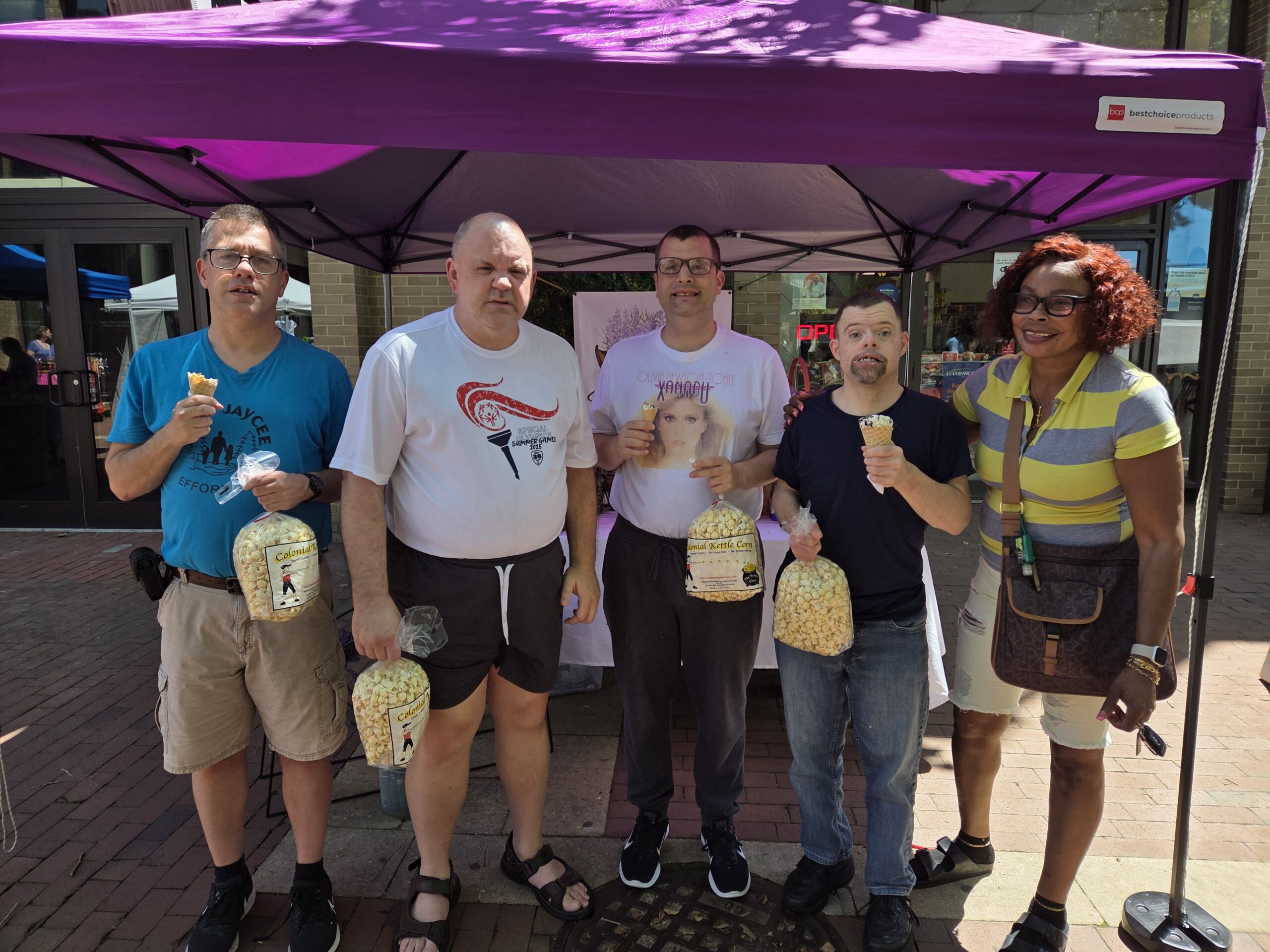 Karen Adams (right), residential counselor at Gabriel Homes, with residents at the Lake Anne Farmer's Market.