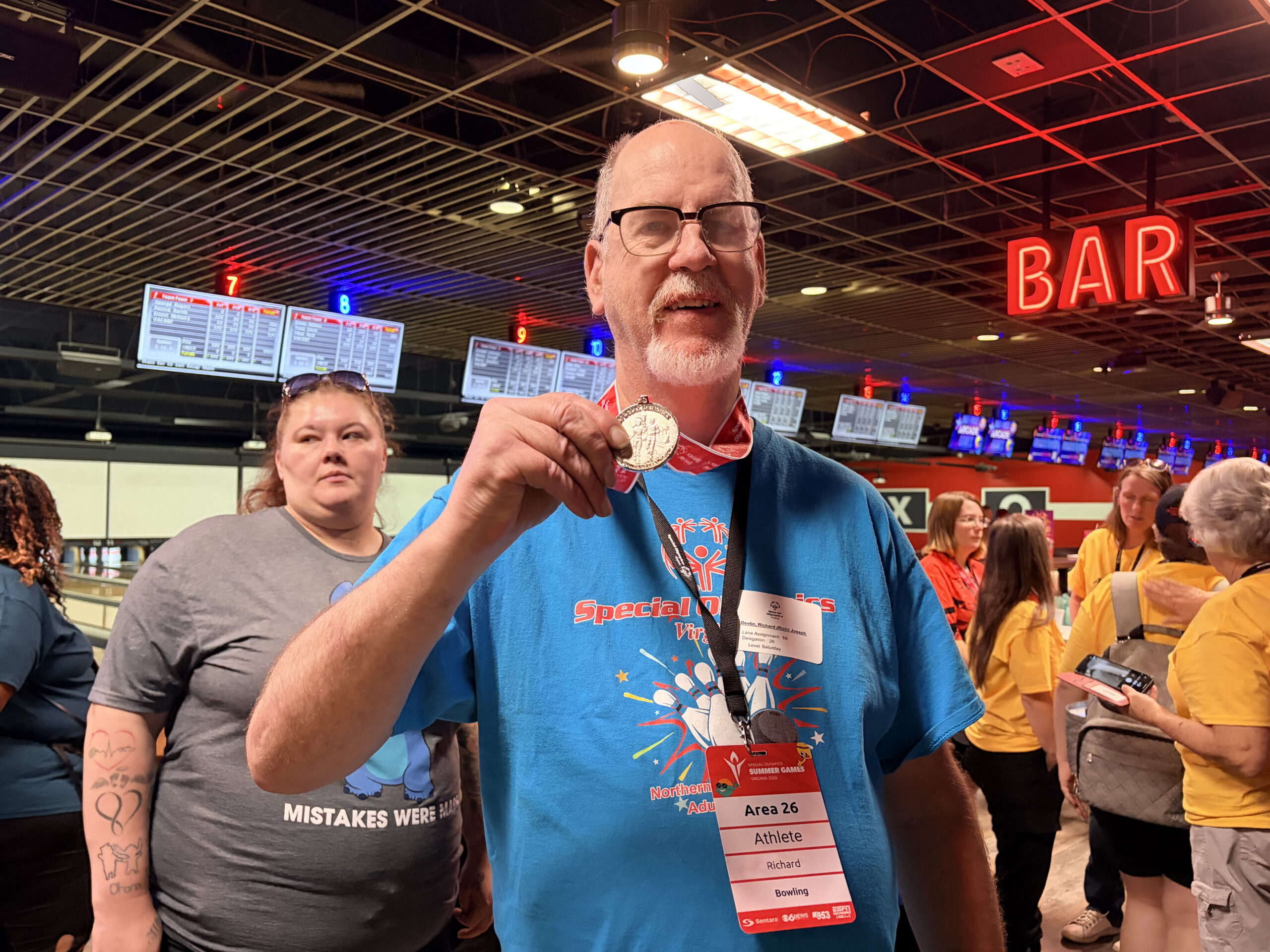 Gabriel Homes resident holding Special Olympics bowling silver medal from state games.
