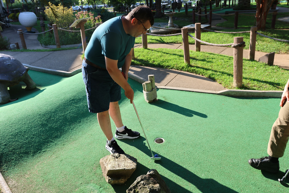 Gabriel Homes resident playing mini golf.