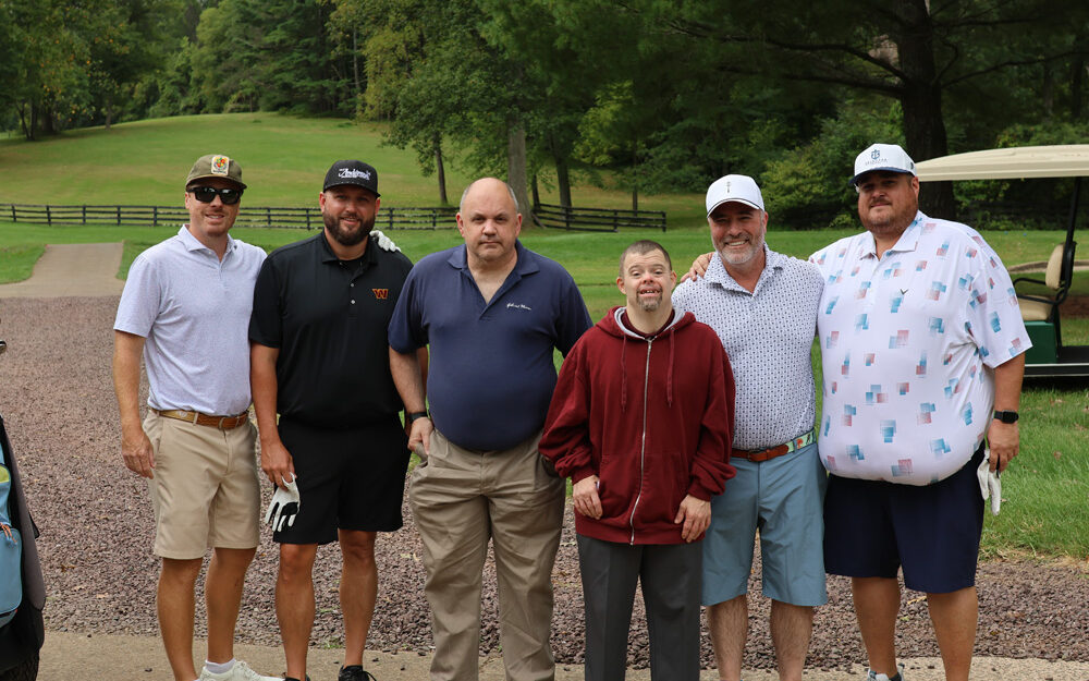 Gabriel Homes residents (center) and golfers at the Gabriel Homes Golf Tournament.