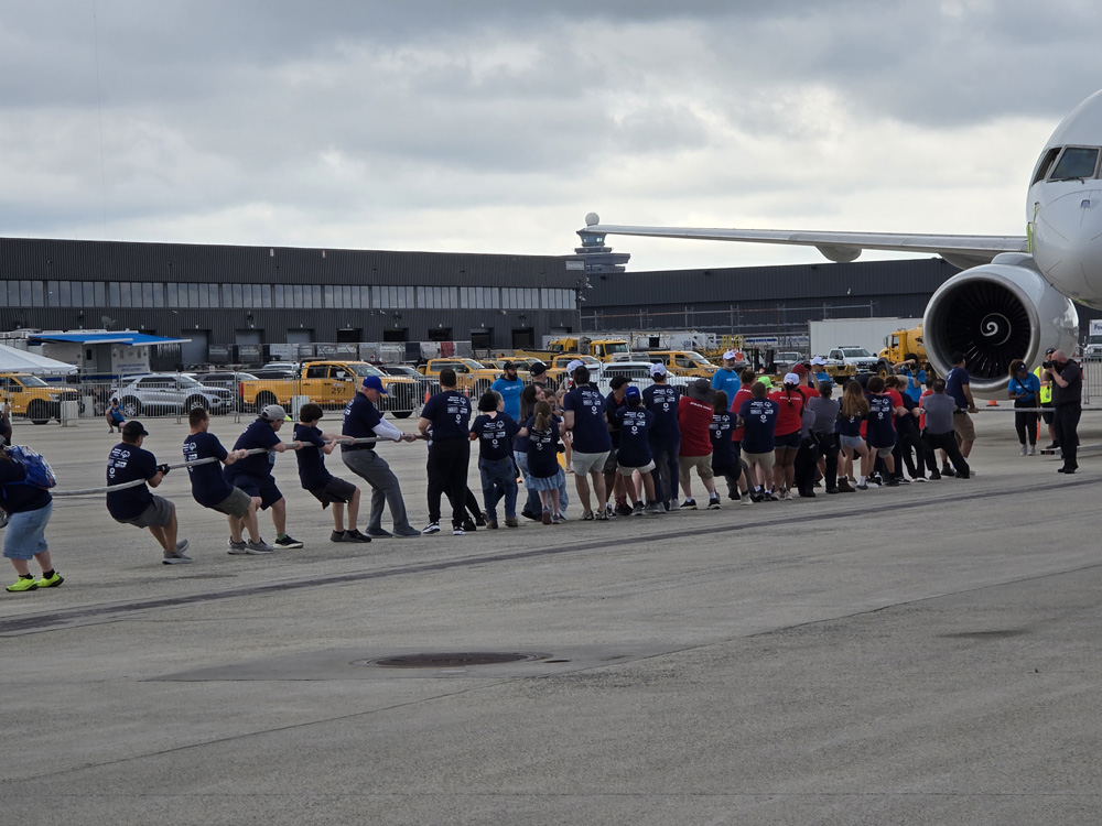 Gabriel Homes residents in Special Olympics powerlifting pulling a plane.