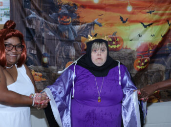 Gabriel Homes resident posing in front of a Halloween backdrop.