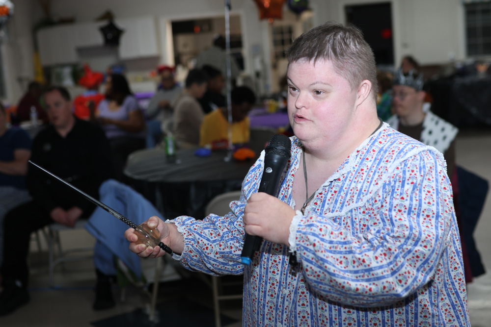 Gabriel Homes resident performing karaoke as the Fairy Godmother.