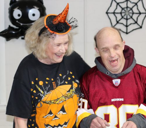 Ruth Cook (left), bookkeeper at Gabriel Homes, laughing with resident (right).