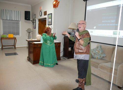 Gabriel Homes resident (right) performing karaoke at the 2024 Boo Bash.