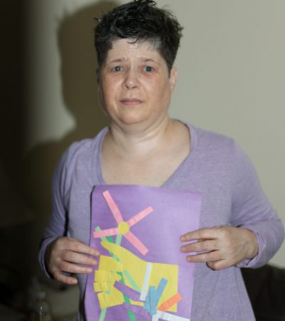 Gabriel Homes resident holding art.