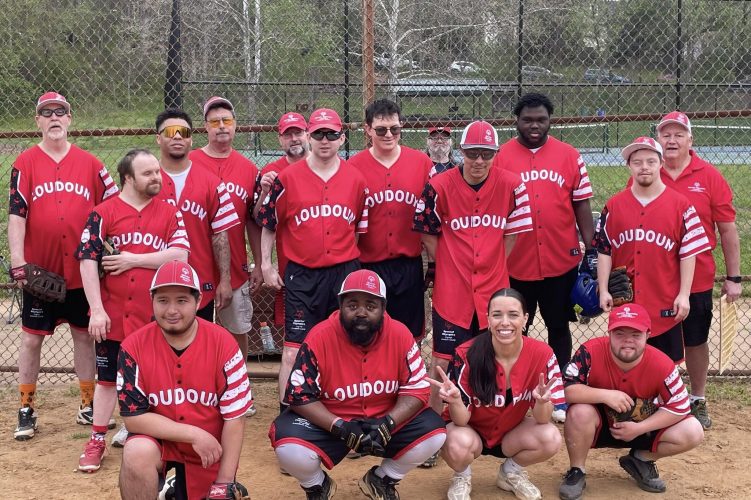 Gabriel Homes resident posing with Loudoun Rangers for Special Olympics softball.