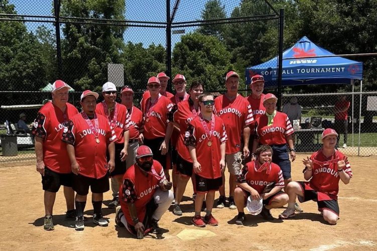 Gabriel Homes resident posing with Loudoun Rangers for Special Olympics softball.