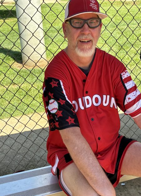 Gabriel Homes resident in the dugout for the Loudoun Rangers, a Special Olympics softball team.