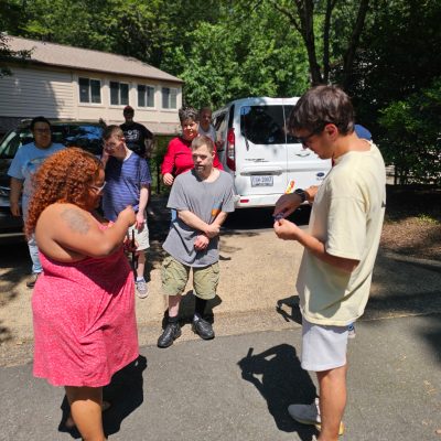 Gabriel Homes staff handing sparklers to residents on Independence Day, July 4, 2025.