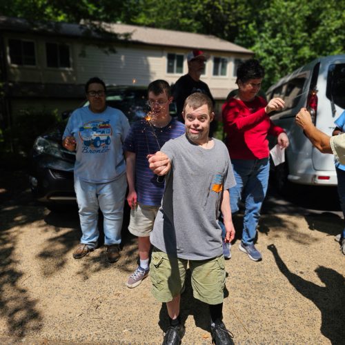 Residents holding sparklers at Gabriel Homes.