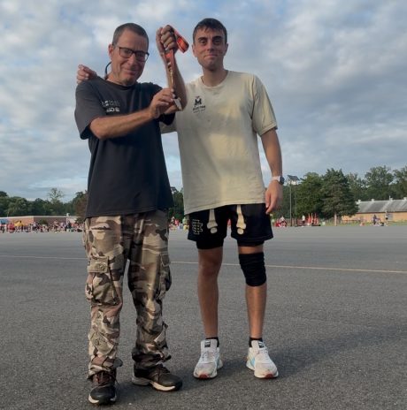 Gabriel Homes resident (left) standing with Daniel Borges, program coordinator at Gabriel Homes, at the Marine Corps 12K in Quantico.
