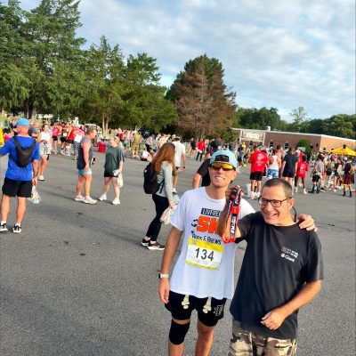 Gabriel Homes resident (left) standing with Daniel Borges, progradm coordinator at Gabriel Homes, at the Marine Corps 12K in Quantico.