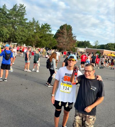 Gabriel Homes resident (left) standing with Daniel Borges, progradm coordinator at Gabriel Homes, at the Marine Corps 12K in Quantico.