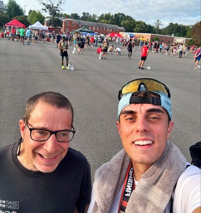 Gabriel Homes resident (left) standing with Daniel Borges, progradm coordinator at Gabriel Homes, at the Marine Corps 12K in Quantico.