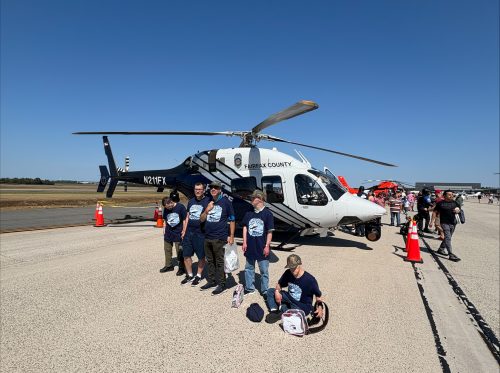 Gabriel Homes residents in front of a helicopter at 2025 Dulles Day.