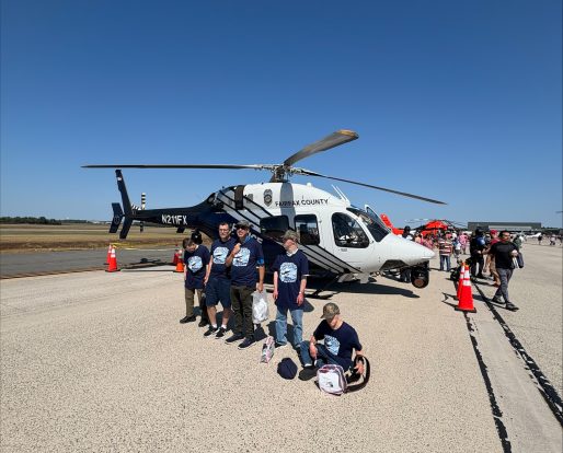 Gabriel Homes residents in front of a helicopter at 2025 Dulles Day.