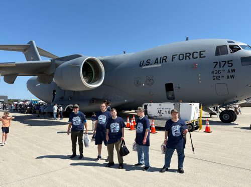 Gabriel Homes residents in front of a plane at 2025 Dulles Day.