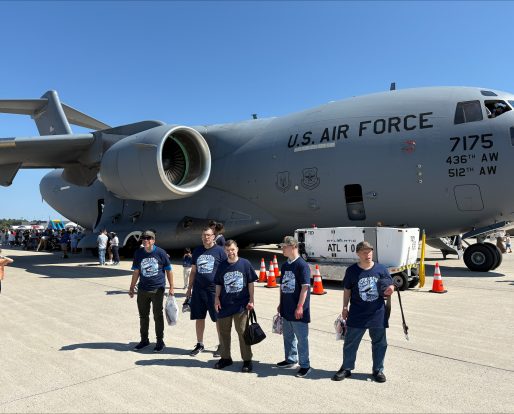 Gabriel Homes residents in front of a plane at 2025 Dulles Day.