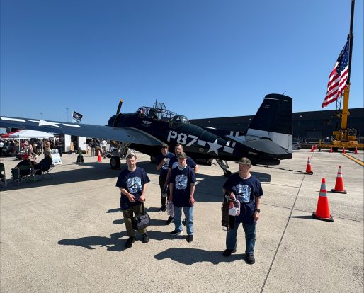 Gabriel Homes residents in front of a plane at 2025 Dulles Day.