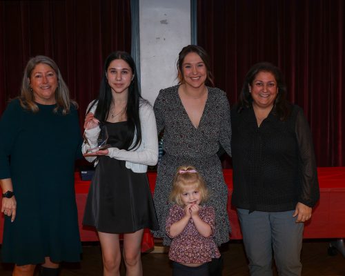 Left to right: Gabriel Homes Executive Director, the Lemay family (second to left to second to right), and Board Chair Michele Bolos.