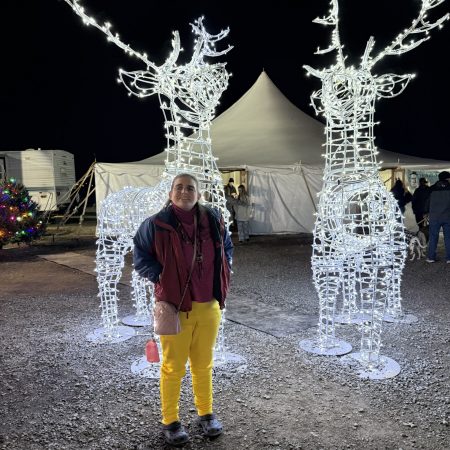 Gabriel Homes resident at a local event in December, seeing the Festival of Lights, pictured in front of lit deer.