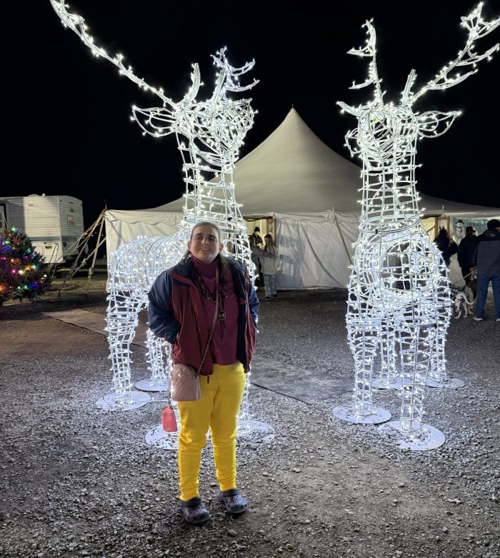 Gabriel Homes resident at a local event in December, seeing the Festival of Lights, pictured in front of lit deer.