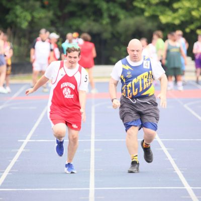 Gabriel Homes resident (right) competing in Special Olympics track and field.