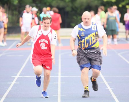 Gabriel Homes resident (right) competing in Special Olympics track and field.