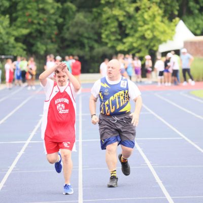 Gabriel Homes resident (right) competing in Special Olympics track and field.