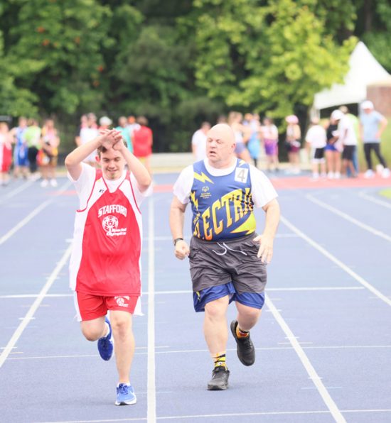 Gabriel Homes resident (right) competing in Special Olympics track and field.