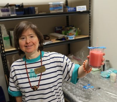 Gabriel Homes resident showing a candle they made at work.