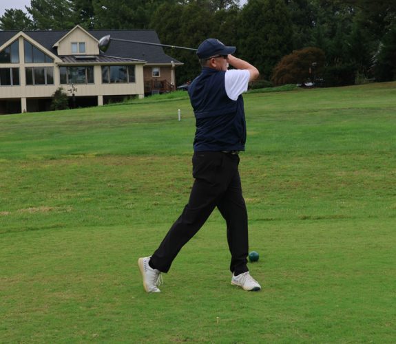Golfer swinging club at the Gabriel Homes 31st Annual Golf Tournament.