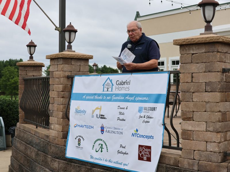 Monsignor Bob Cilinski delivering remarks at the Gabriel Homes Golf Tournament.