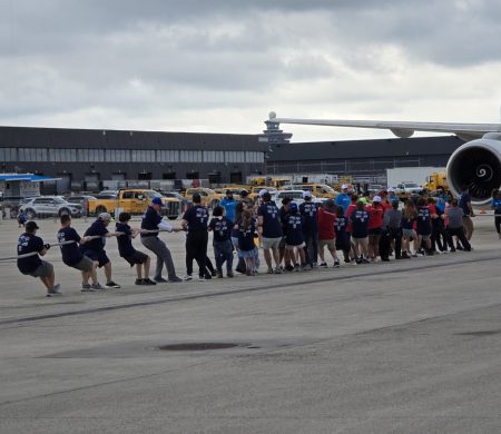 Gabriel Homes residents in Special Olympics powerlifting pulling a plane.