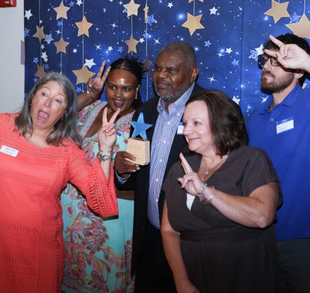 Gabriel Homes staff posing with Reuben Sidifall (center, holding his award) at the 2026 DSPY Awards.