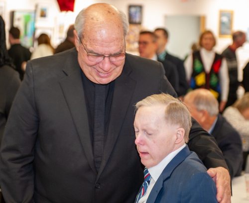 Gabriel Homes resident (right) with Father Bob Cilinski (left).