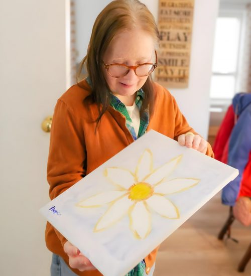 Gabriel Homes resident holding painting.