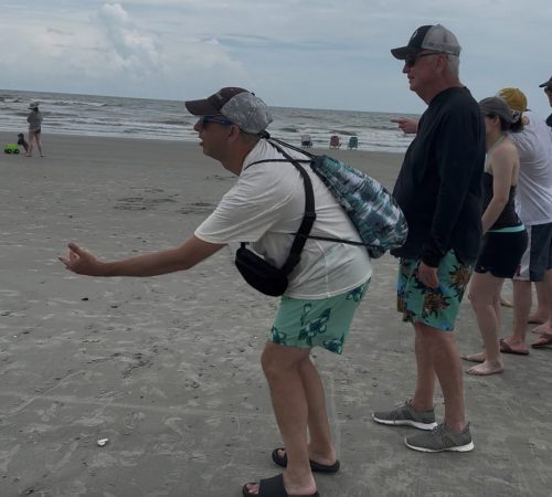 Gabriel Homes resident playing bocce on the beach.