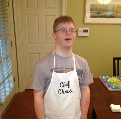 Gabriel Homes resident wearing apron. Gabriel Homes resident wearing apron.